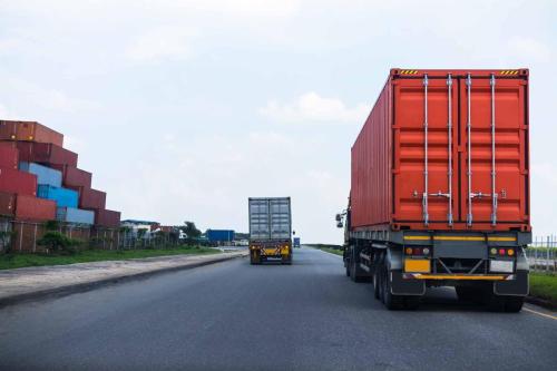 back-view-red-container-truck-ship-port-logistics-copy